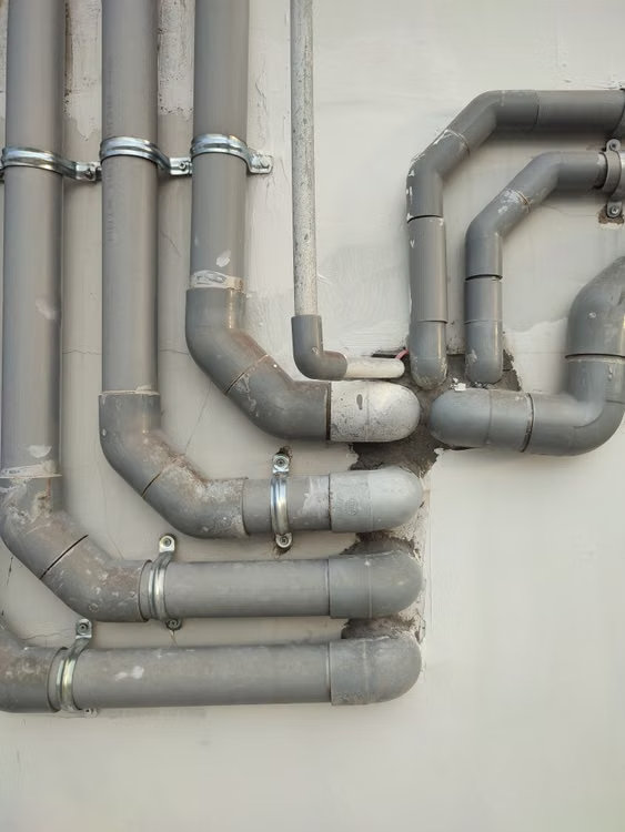 Neatly installed PVC plumbing pipes and fittings